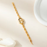 Helena® - Reloj dorado con esfera ovalada y marco negro