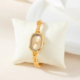 Helena® - Reloj dorado con esfera ovalada y marco negro